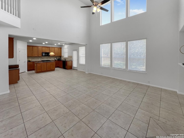 unfurnished living room featuring light tile patterned floors and baseboards