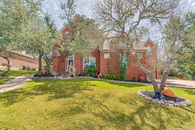 view of front of property featuring brick siding and a front lawn