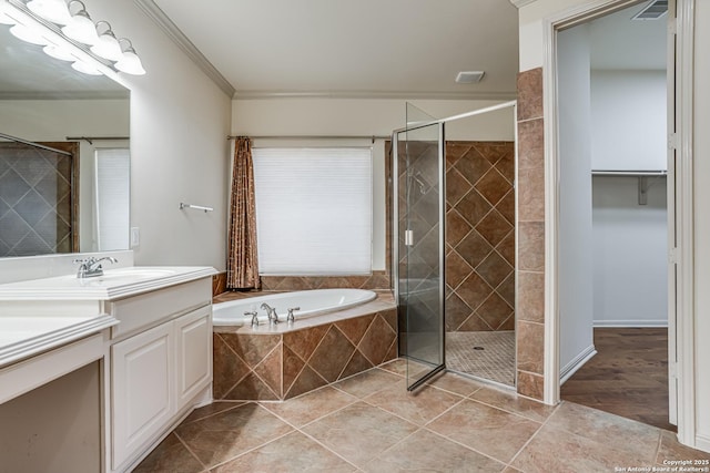 bathroom featuring tile patterned floors, visible vents, a shower stall, a bath, and vanity