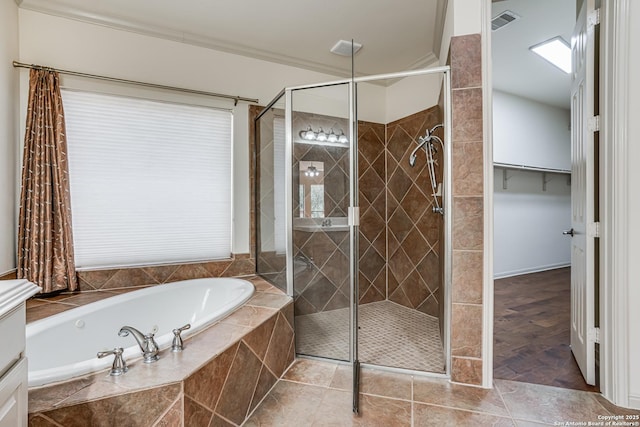 bathroom with visible vents, a stall shower, and a garden tub