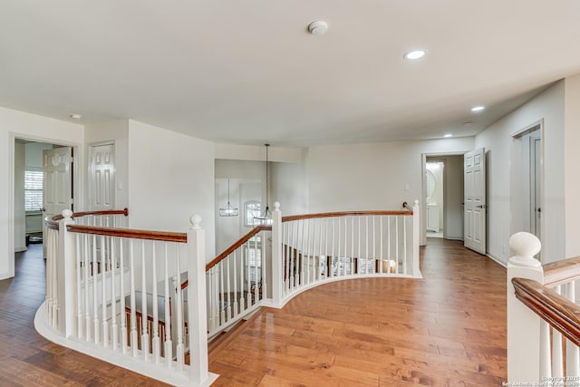 hall featuring recessed lighting, an upstairs landing, and hardwood / wood-style floors