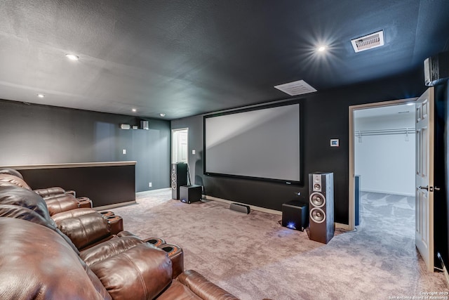 carpeted home theater room with visible vents, recessed lighting, a textured ceiling, and baseboards