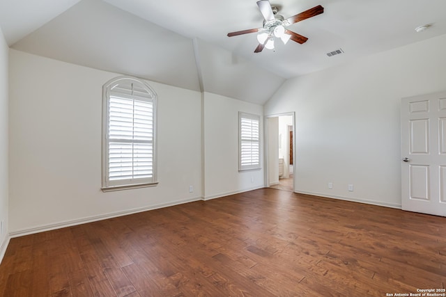 unfurnished room featuring visible vents, wood finished floors, a ceiling fan, and vaulted ceiling