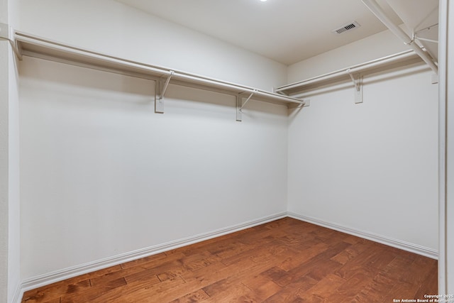 walk in closet featuring visible vents and wood finished floors