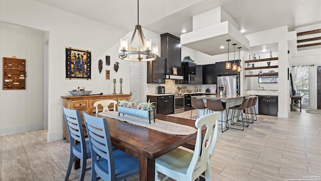 dining space featuring wood finish floors, baseboards, a notable chandelier, and recessed lighting