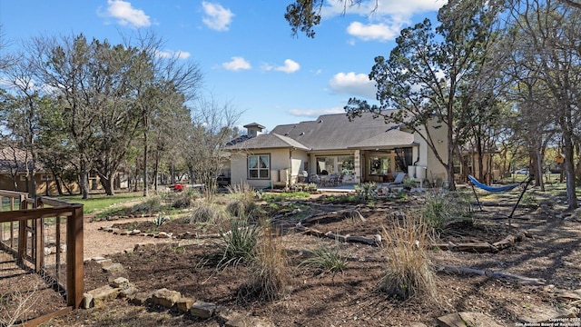 back of property with stucco siding and a patio