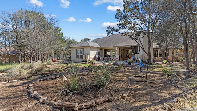 back of house featuring stucco siding and a patio