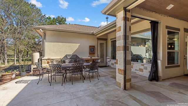 view of patio / terrace featuring outdoor dining space and grilling area