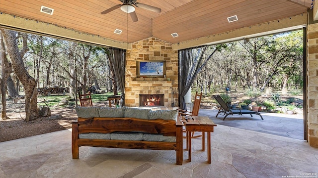 view of patio / terrace with visible vents, an outdoor stone fireplace, and ceiling fan