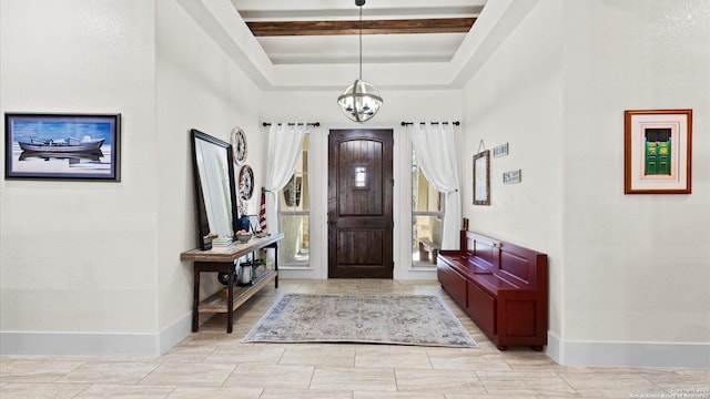 foyer with beamed ceiling, baseboards, a raised ceiling, and an inviting chandelier