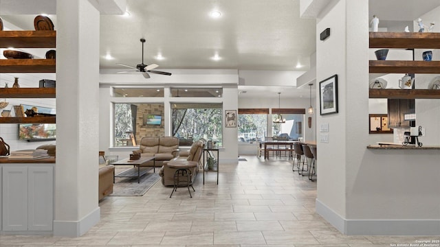 living room with recessed lighting, baseboards, and ceiling fan