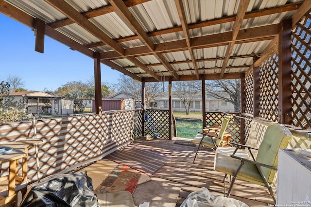 wooden deck with an outbuilding and a storage shed