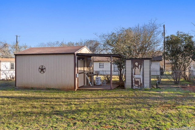 view of shed featuring fence