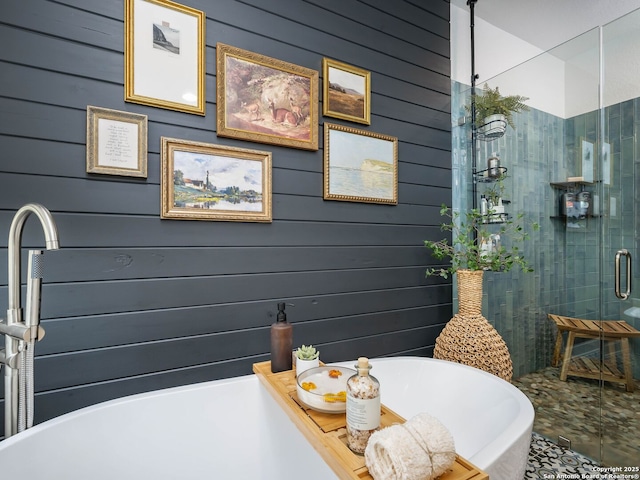 full bath featuring a soaking tub and a stall shower