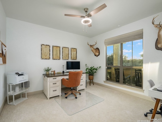 office area with baseboards, light colored carpet, and ceiling fan