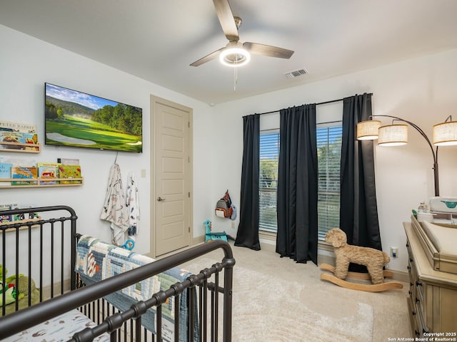 carpeted bedroom with baseboards, visible vents, and ceiling fan