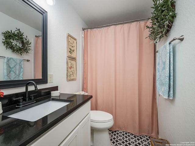 bathroom featuring toilet and vanity