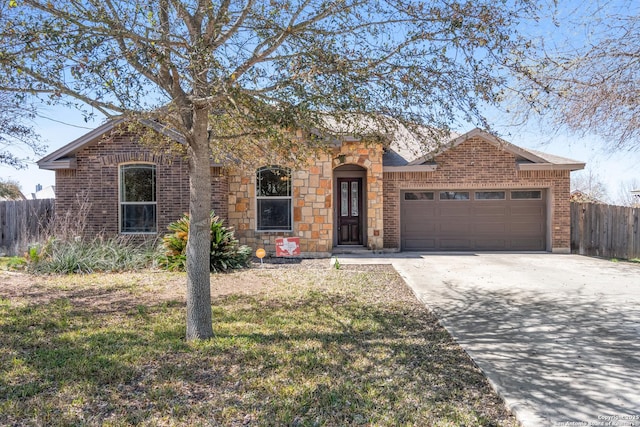 single story home with brick siding, fence, concrete driveway, a front yard, and an attached garage