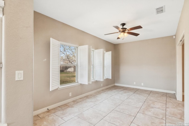 unfurnished room featuring light tile patterned floors, a ceiling fan, visible vents, and baseboards