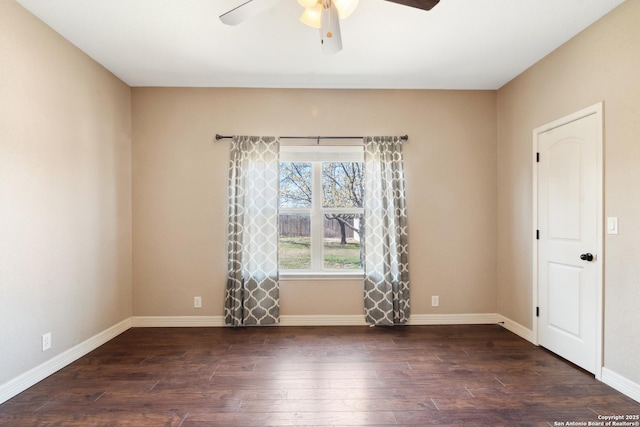 spare room with baseboards, hardwood / wood-style floors, and a ceiling fan