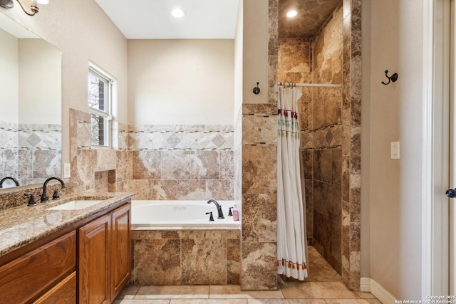 bathroom featuring tile patterned flooring, a bath, vanity, and a tile shower