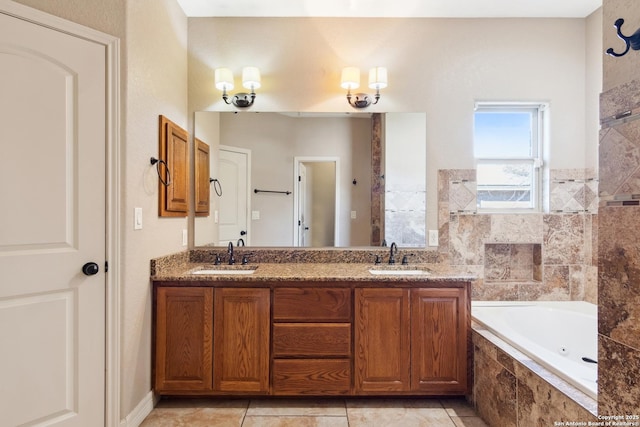 bathroom with double vanity, a jetted tub, tile patterned floors, and a sink