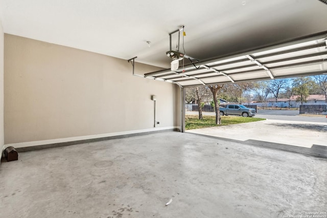 garage with a garage door opener and baseboards