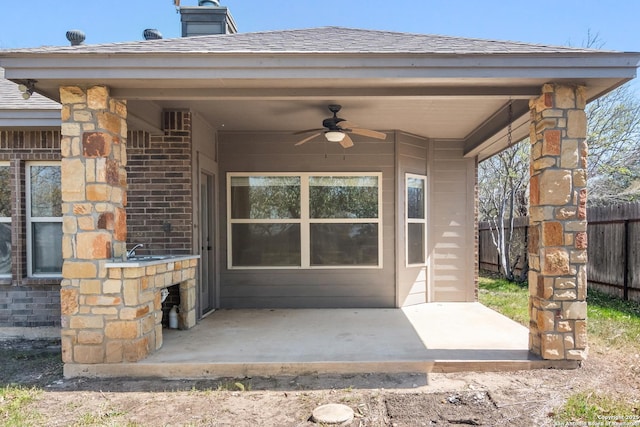 view of patio / terrace featuring a ceiling fan and fence