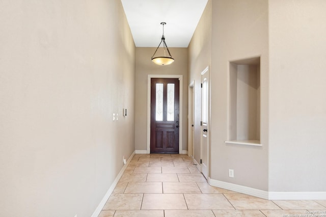 entryway featuring light tile patterned floors and baseboards