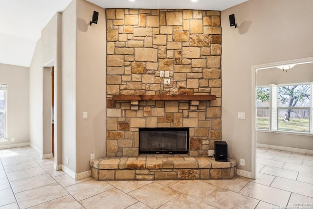 details featuring a fireplace and baseboards