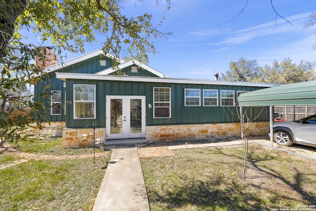 view of front of home with french doors and a chimney