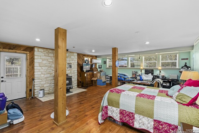 bedroom with recessed lighting, ornate columns, and wood finished floors