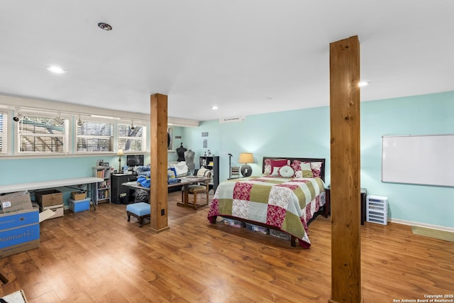 bedroom featuring recessed lighting and wood finished floors