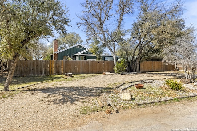 view of yard featuring a detached carport and fence