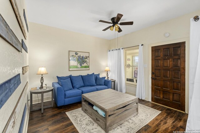 living area featuring dark wood-style floors and a ceiling fan