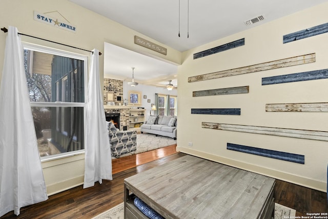 interior space with wood finished floors, visible vents, and baseboards