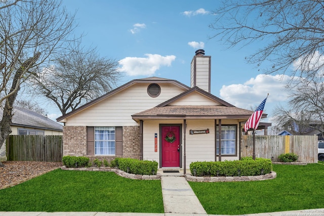 bungalow featuring brick siding, a chimney, a front yard, and fence