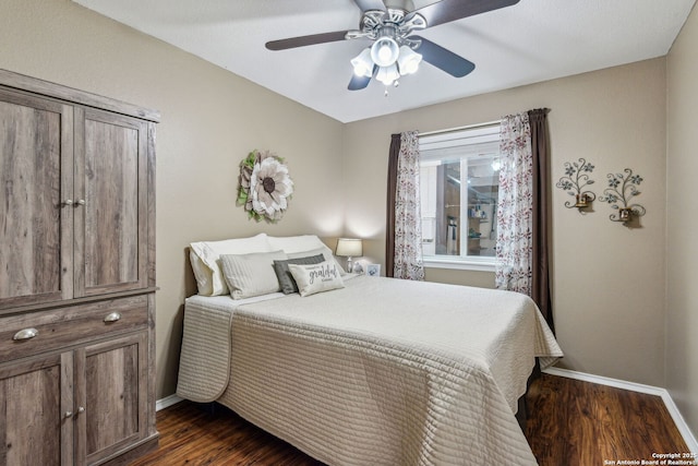 bedroom featuring dark wood finished floors, a ceiling fan, and baseboards