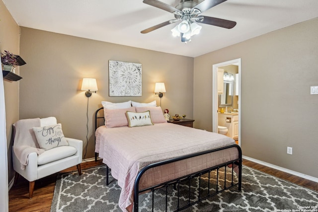 bedroom with ceiling fan, dark wood-type flooring, baseboards, and connected bathroom