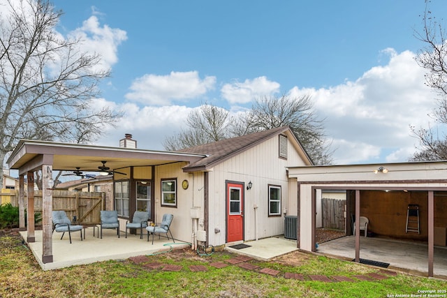 back of house featuring a ceiling fan, fence, a chimney, central air condition unit, and a patio area