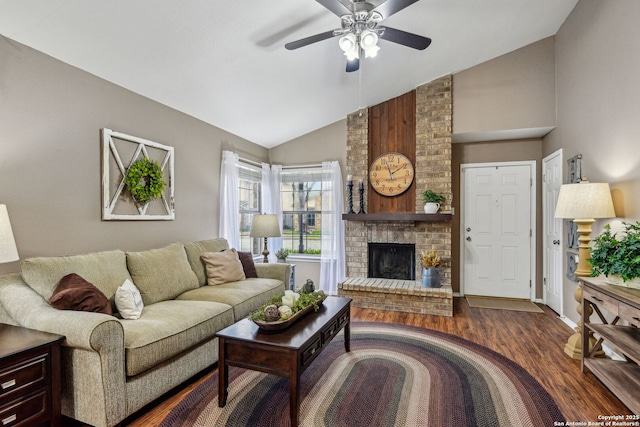 living area featuring a fireplace, high vaulted ceiling, wood finished floors, and ceiling fan