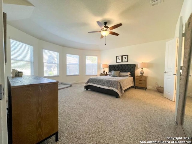 bedroom featuring visible vents, baseboards, carpet, and a ceiling fan