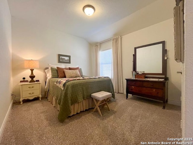 bedroom featuring baseboards, carpet floors, and vaulted ceiling