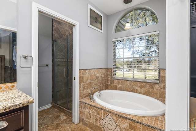 full bath with vanity, a garden tub, and a stall shower