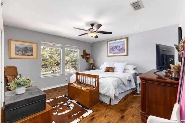 bedroom with visible vents, ceiling fan, dark wood-type flooring, and baseboards