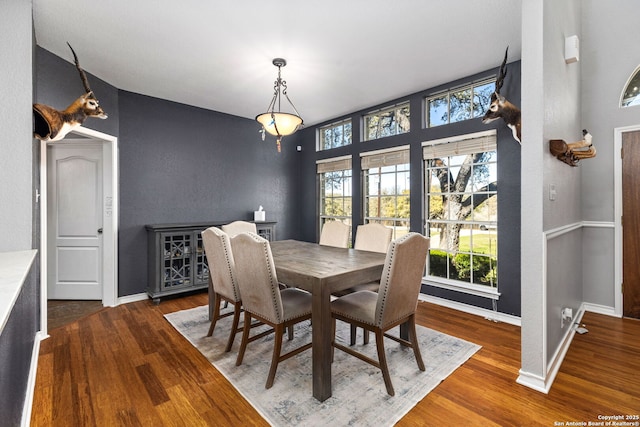 dining space with dark wood-style floors and baseboards