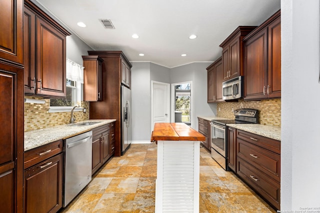 kitchen featuring a sink, stainless steel appliances, plenty of natural light, and visible vents