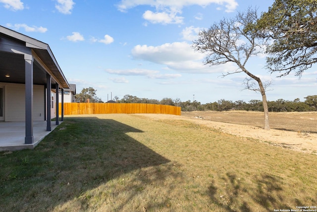 view of yard featuring a patio and fence