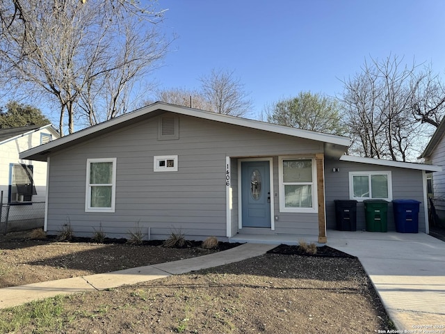 bungalow featuring fence