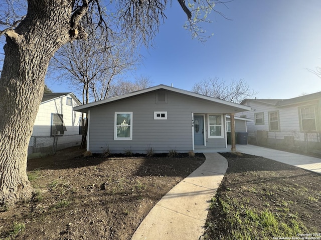 bungalow-style house with fence